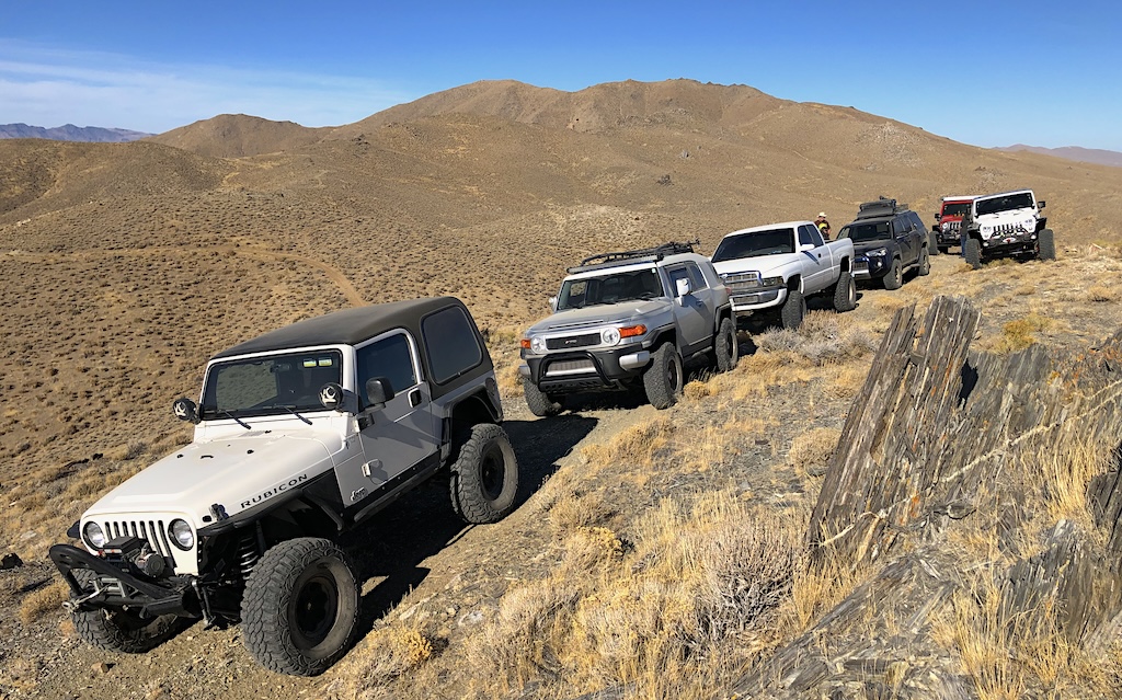 Off road jeeps and trucks driving on a trail