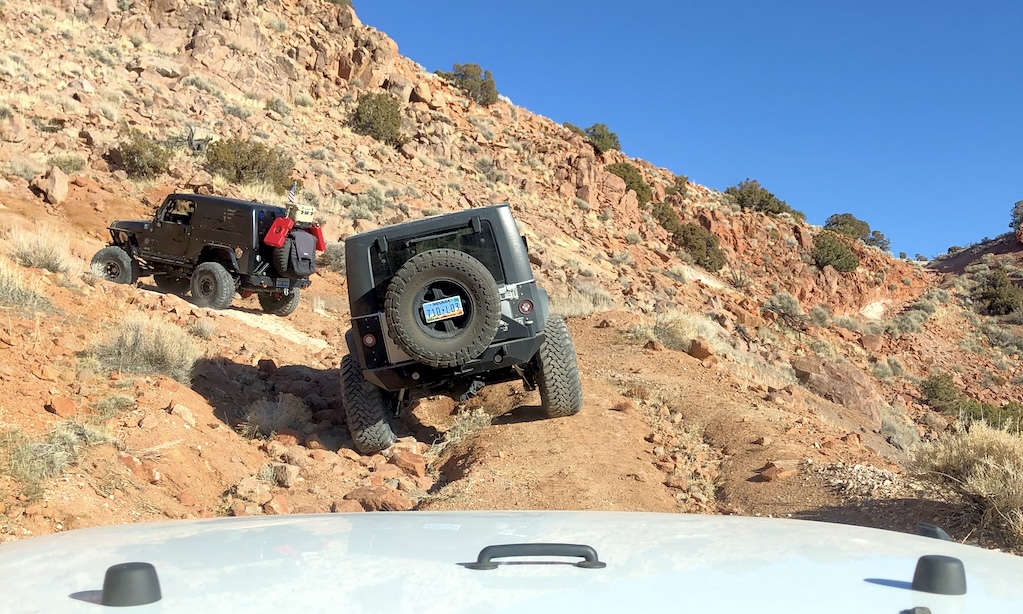 Jeeps spaced out correctly driving off road on a hill